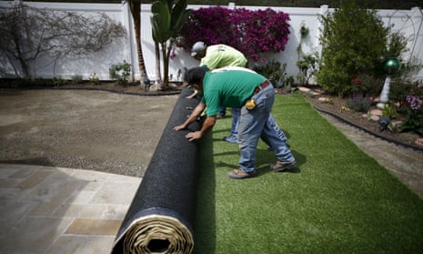 Rolling out artificial turf at a property in California
