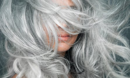 A woman with thick silver hair obscuring most of her face