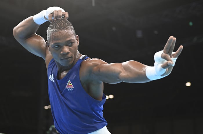 Mozambique’s Tiago Osorio Muxanga reacts after winning his men’s light middleweight semi-final boxing bout against Tanzania’s Kassim Mbundwike.