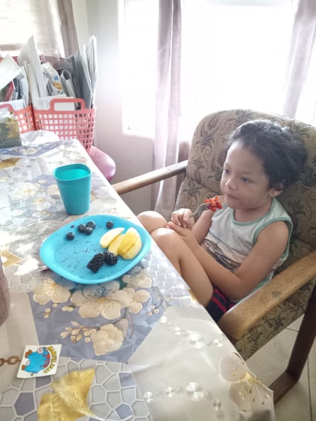 young kid eating fruit