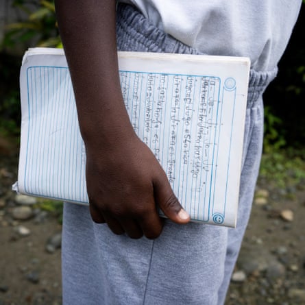 Luis Escobar holds his notebook on his last day of classes at the Playa de Oro community school.