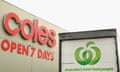 A Woolworths truck is parked outside a Coles Supermarket