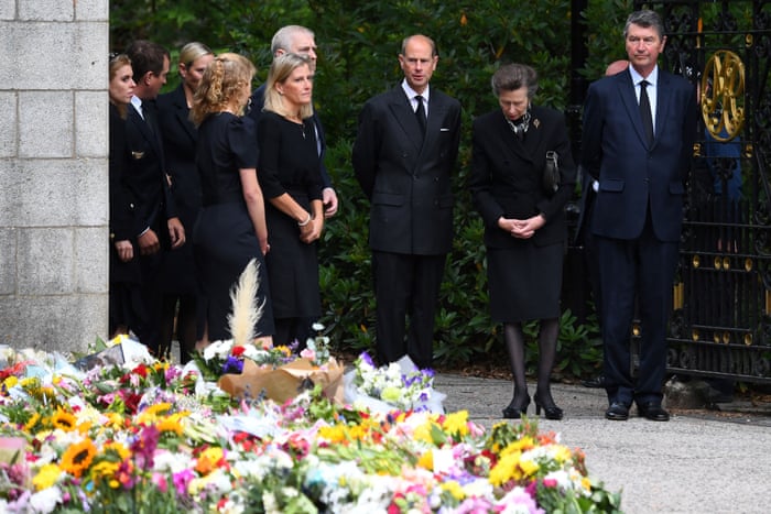 Sophie, Countess of Wessex; Prince Andrew; Edward, Earl of Wessex; Princess Anne and Vice Admiral Timothy Laurence look at the flowers outside Balmoral Castle.