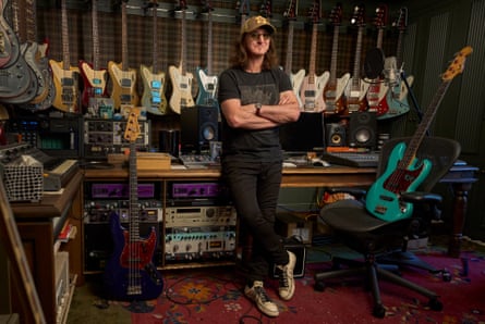 Geddy Lee surrounded by guitars and music kit