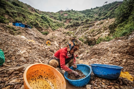 A woman sorts through stones looking for gold at D3 mine in Kamituga.