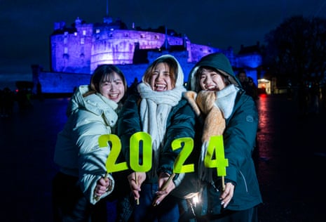 University students from Japan pictured during tonight’s Hogmanay New Year celebrations in Edinburgh, where they may have significantly better weather than England and Wales.