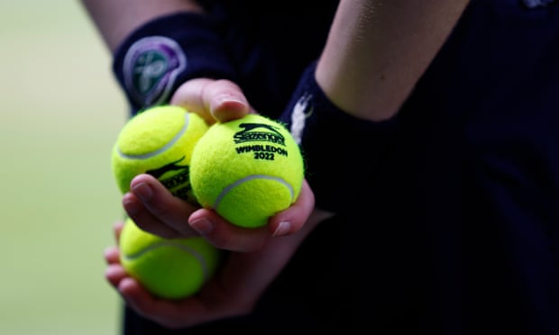Tom Jenkins’ best shots of Wimbledon 2022 – in pictures | Wimbledon 2022 9 A ballboy holds tennis balls on Centre Court.