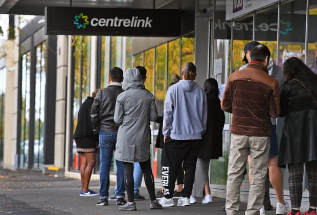 People queue up outside a Centrelink office in Melbourne 