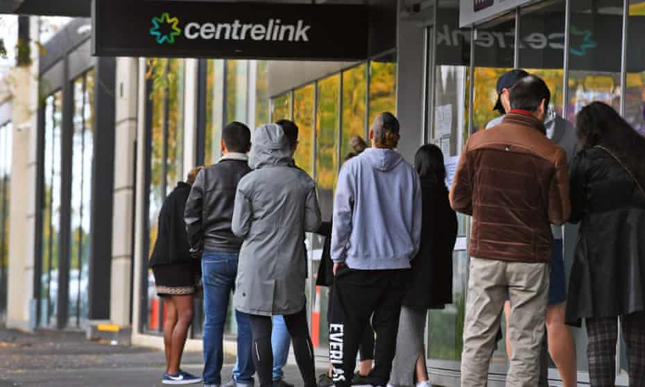 People queue up outside a Centrelink office in Melbourne