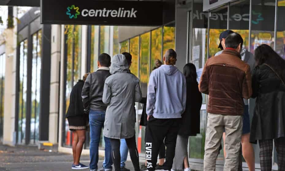 People queue outside a Centrelink office in Melbourne in April