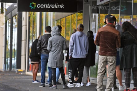 People queue up outside a Centrelink office in Melbourne in April