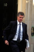 Jonathan Powell steps outside No 10 Downing Street; he carries folders and documents in one arm