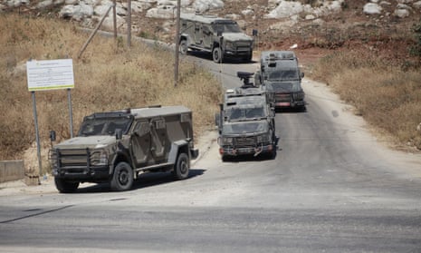 Israeli armoured vehicles drive on a road during a raid in Tubas city in the occupied West Bank on 14 August 2024.