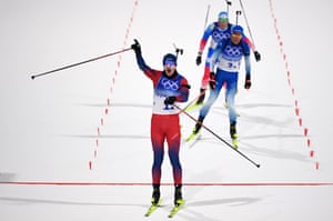 Johannes Thingnes Boe crosses the line for victory for Norway in the Biathlon Mixed Relay.