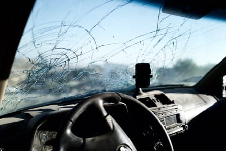 A car windscreen shattered by a projectile