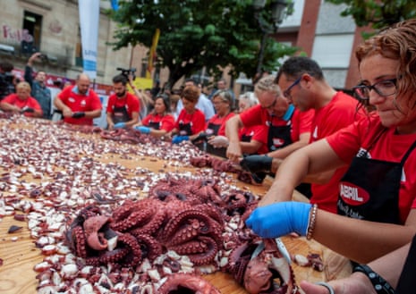 People prepare a giant octopus ‘tapa’ to try to break a new world record in O Carballino in Galicia. 