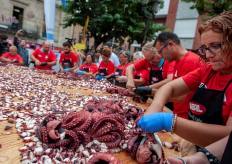 People prepare a giant octopus ‘tapa’ to try to break a new world record in O Carballino in Galicia.