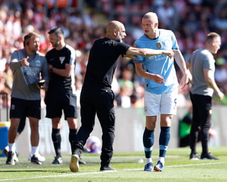 Pep Guardiola passes on instructions to Erling Haaland during Manchester City’s goalless draw at Southampton