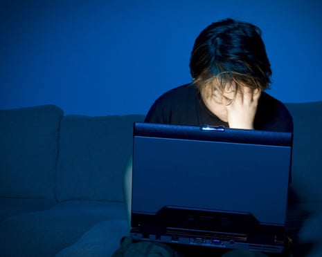 Boy using computer at night