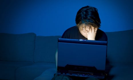 Boy using computer at night