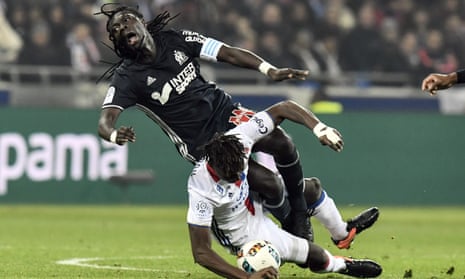 Marseille’s Bafetimbi Gomis is tackled by Mapou Yanga-Mbiwa during Lyon’s Ligue 1 win on Sunday.