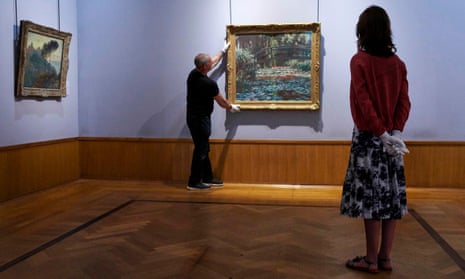 A Monet Waterlilies painting being hung at the Barber Institute of Fine Arts, University of Birmingham.