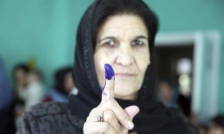 An Afghan woman shows her inked finger after in the parliamentary elections in 2018.