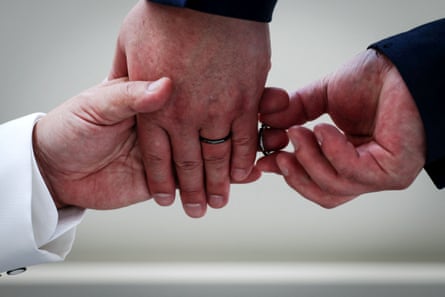 A male couple exchange rings