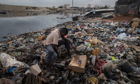 A fisherman looks for bait at a shanty town in the south of Luanda.