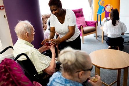 Care home staff handing cold drinks to residents during the extreme heat.
