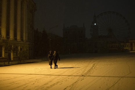 People walk in the snow in central Kyiv.