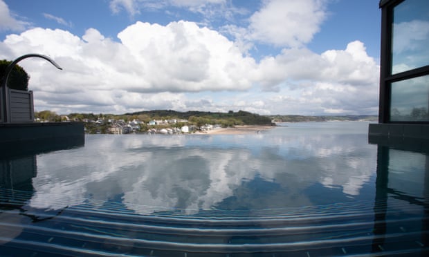 The infinity pool reflects the clouds and overlooks the Welsh coast