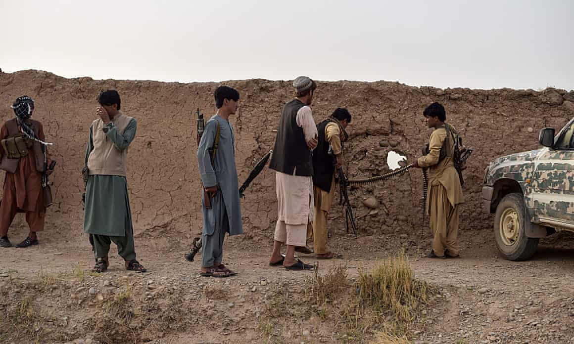 Members of an anti-Taliban militia take position during fighting with Taliban insurgents earlier this year