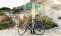 A bicycle leaning against a road sign along the Camel Trail cycleway in Cornwall, England, United Kingdom.
