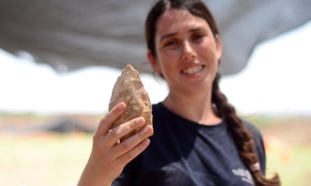Maayan Shemer of the Israel Antiquities Authority showing a half-million-year-old hand-axe.