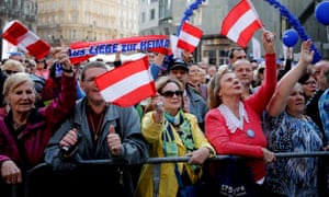 Austrian Freedom party supporters wave flags in Vienna