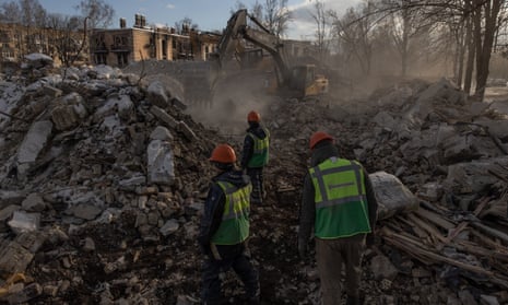 Demolition employees work on a site of a demolished residential building that was heavily damaged during Russian attacks in Hostomel, Ukraine.