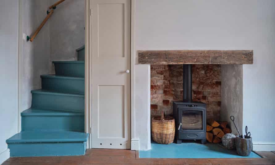 The staircase and hearthstone in the living room are painted blue