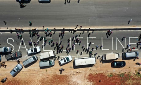 SYRIA: President Assad sworn in for fourth term with 95% of vote 8 A human chain is formed by aid workers, medical and rescue services in a vigil calling for the Bab al-Hawa crossing to be kept open, near Bab al-Hawa, 2 July