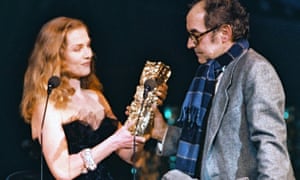 Isabelle Huppert presents Jean-Luc Godard with the 1987 Honorary César Award at the the annual French film industry award ceremony in Paris on 7 March 1987