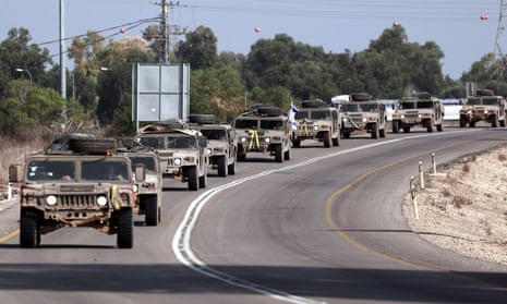 Israeli army vehicles on a road close to the southern Israeli city of Sderot, 23 October 2023.
