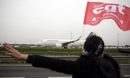 An Air France employee waves a CGT union flag