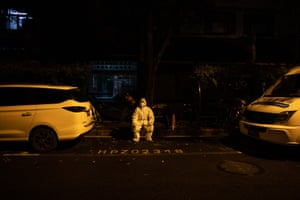 Li Jianguo, a community worker, on duty during the night at the Guangfu residential area in Yuyuan sub-district