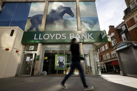 A pedestrian walks past a branch of Lloyds Bank in London.