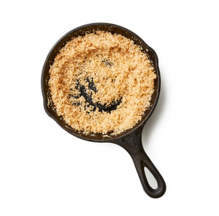 03a Felicity Cloake’s perfect chicken rendang. Desiccated coconut, looks like rice. Put a tablespoon of the oil in a frying pan on a medium heat, then fry the coconut, stirring, until deep golden brown; if using fresh grated coconut, do the same, but without the oil. Pound the fried coconut to a paste while it’s still warm.