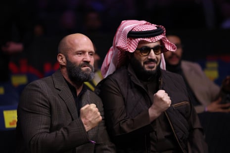 Jason Statham, left, poses with Turki al-Sheikh at ringside.
