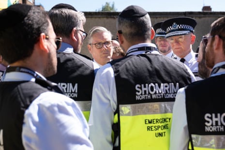 Prime minister Keir Starmer and Metropolitan police commissioner Sir Mark Rowley speak with responders from Shomrim.