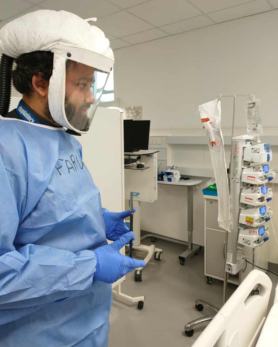 Imam Faruq Siddiqi, Muslim chaplain at the Royal London hospital in London, attending to someone on a Covid ward.