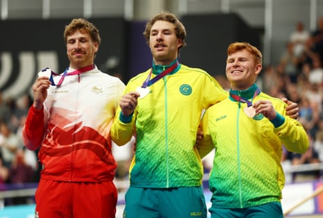 Gold medallist Australia's Leigh Hoffman celebrates on the podium after winning the Men's 1000m Time Trial with silver medallist England's Joseph Truman and bronze medallist Australia's Tayte Ryan.