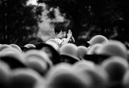 Beijing, China - 1989: A young boy welcomes Chinese soldiers approaching Tiananmen Square, just a few hours before the massacre had begun, unaware of the significance of the army occupation of Beijing.